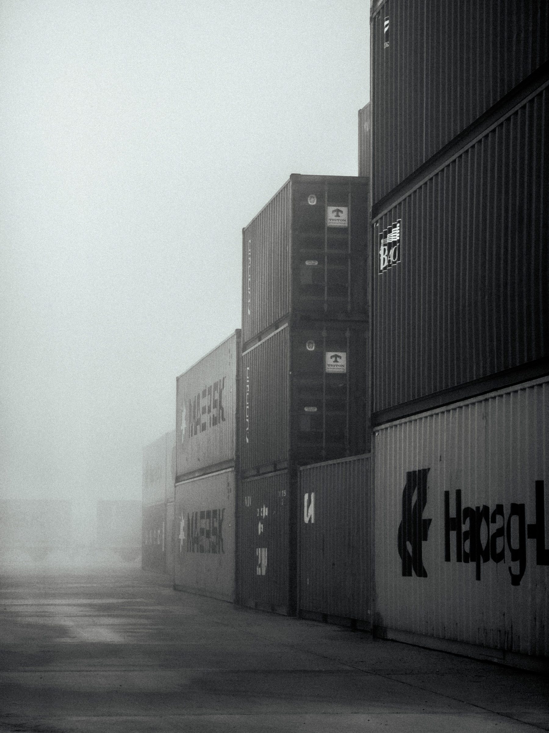 Shipping port with stacked containers